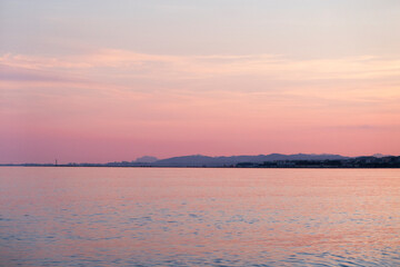 sea and sky in pastel violet and pink sunset colors