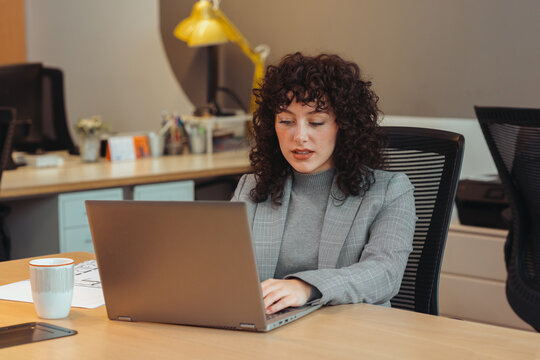 Pensive woman using laptop