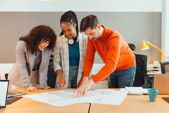 Group of diverse colleagues working on project in office