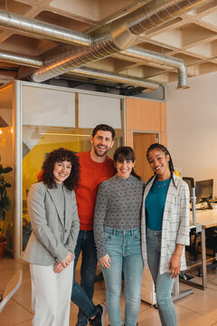 Portrait of happy diverse colleagues in start-up office
