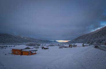 Sunrise panoramic view of Waidegg near Tressdorf on the border between Italy and Austria. Nassfeld ski resort in 5km. January 2022.