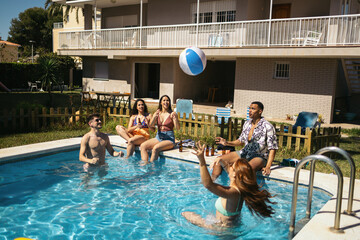 Friends playing and having fun in the pool