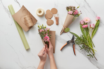 Woman working on pink spring bouquets.