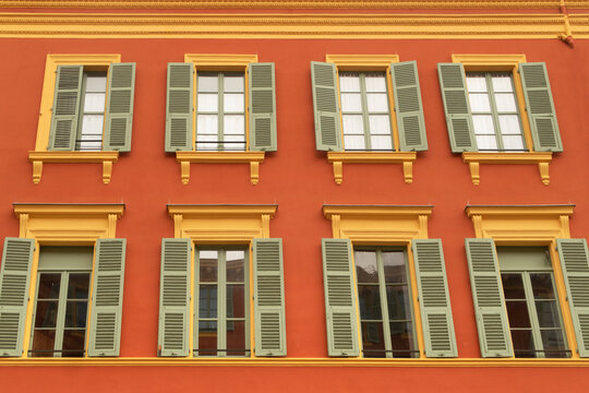 stylish orange building facade with green window shades