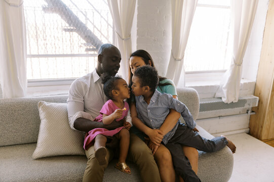 Happy family sitting together in their home in their living room