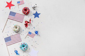 Composition with donuts, USA flags and confetti on white table. Independence Day celebration
