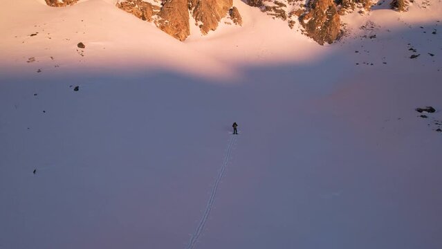 Splitboarder Standing Under Large Snowy Mountains At Sunset - Flyaway 