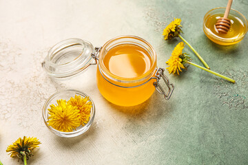 Obraz na płótnie Canvas Jar and bowls with dandelion honey on white background