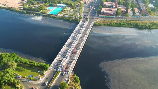 Drone video of a bridge with still water under it beside a beach in southern part of India, Chennai, Napier bridge