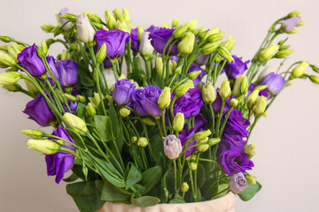 Vase with eustoma flowers on white background