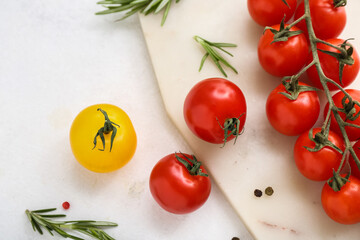 Fototapeta na wymiar Board with fresh cherry tomatoes and rosemary on white background