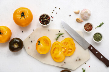 Board with fresh tomatoes and peppercorn on white background