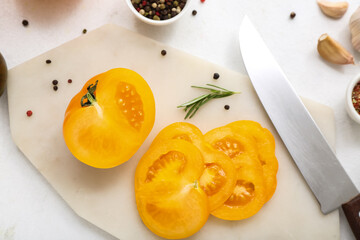 Board with fresh tomatoes and peppercorn on white background