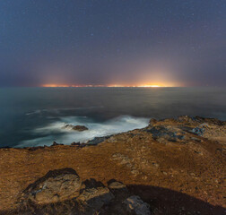 Night landscape of Teide and the lights of Tenerife from Punta de Sardina, in the northwest of Gran Canaria