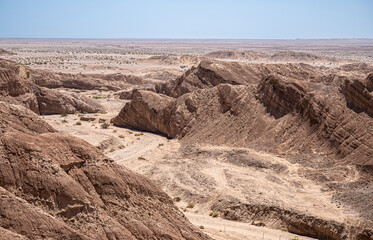 Borrego Springs, CA, USA - April 24, 2023: Ocotillo Wells viewpoint along Borrego Salton Sea Way or S22 shows brown stone cliff and hills leading to flat sandy desert as far the eye can see