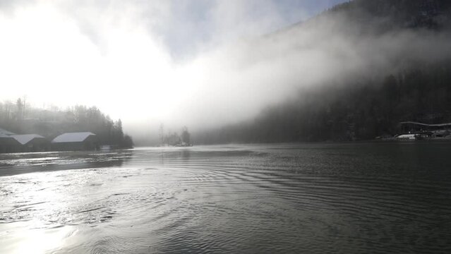 German lake in mist and sun in Koenigssee national park