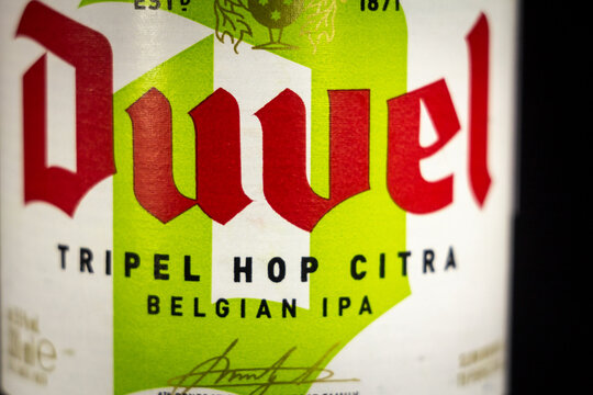LIEGE, BELGIUM - APRIL 21, 2023: Selective blur on a Duvel Tripel Hop citra beer label on a bottle. Duvel is a belgian beer produced by the Moorgat brewery in Flanders.