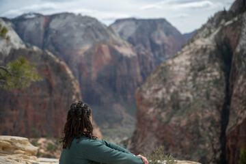 A man looking out at the view of Zion National Park