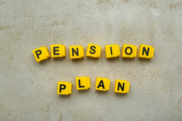 Fototapeta premium Words Pension Plan made of yellow cubes on light textured table, flat lay