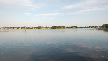 Wide angle view Coffee Pot Bay in Saint Petersburg, FL. Sunny day with blue sky and calm water. With green trees.