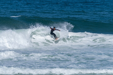Surfer riding waves in Furadouro Beach