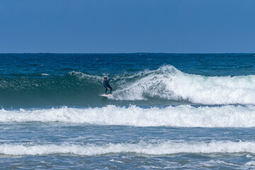 Surfer riding waves in Furadouro Beach