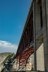 Looking Up at a Tall Bridge Over the River