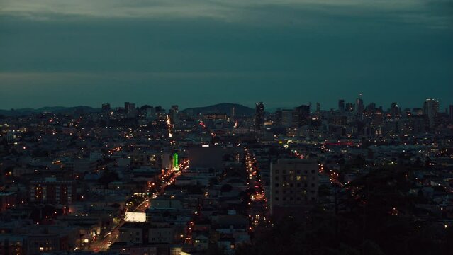Panning clip showing cityscape lit up at night from left to right