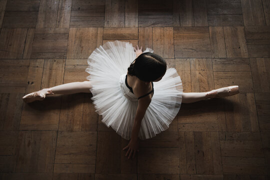 Fototapeta ballerina stretching on the floor 
