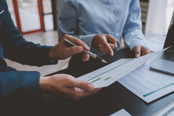 business group meeting Team work with project planning documents Calculate the budget, consult, analyze, summarize the performance on the desk in the office.