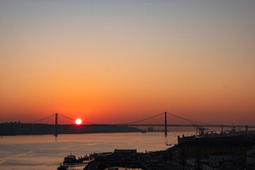 Fototapeta na wymiar View of the Tagus river and Ponte 25 de Abril bridge at sunset. Lisbon. Portugal.