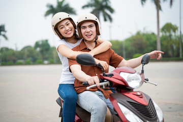 Young Asian couple on the motorbike