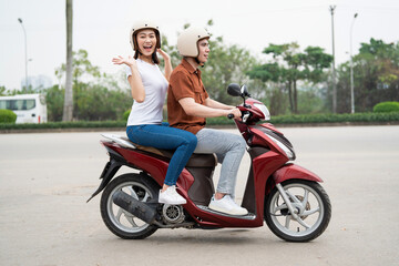 Fototapeta na wymiar Young Asian couple on the motorbike