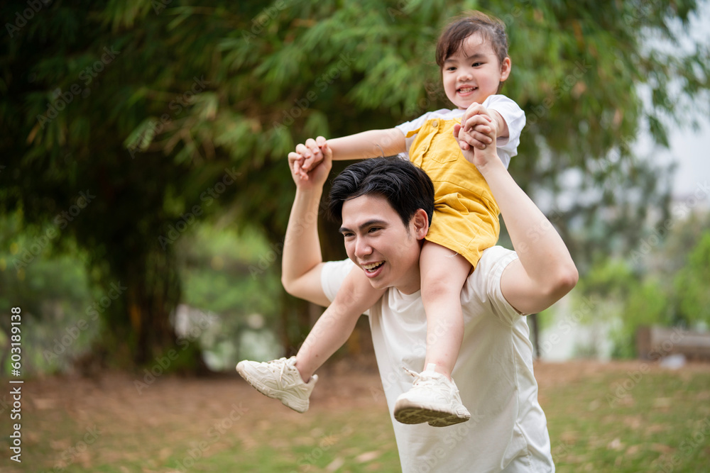 Wall mural Image of young Asian father and daughter