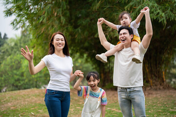 Fototapeta premium Young Asian family in the park