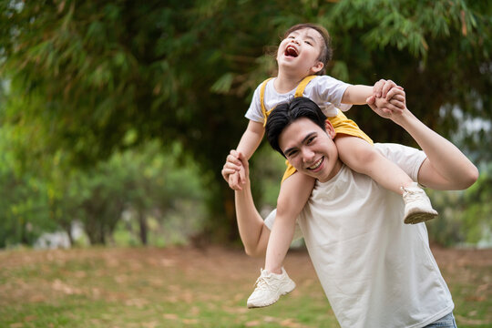 Image of young Asian father and daughter