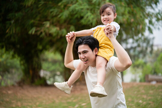 Image of young Asian father and daughter