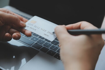 Women holding credit card and using smartphones at home.Online shopping, internet banking, store online, payment, spending money, e-commerce payment at the store, credit card, concept