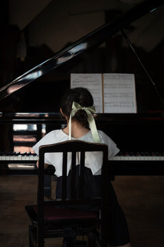 Young girl playing piano
