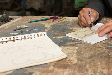 The Creative Process: Ironwork Artist Drawing Plans for Their Next Piece