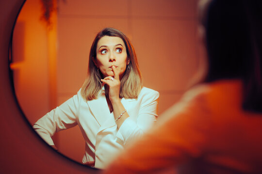 Businesswoman Looking in the Mirror Wondering and Planning. Woman having self-doubt mixed feelings about her ideas 


