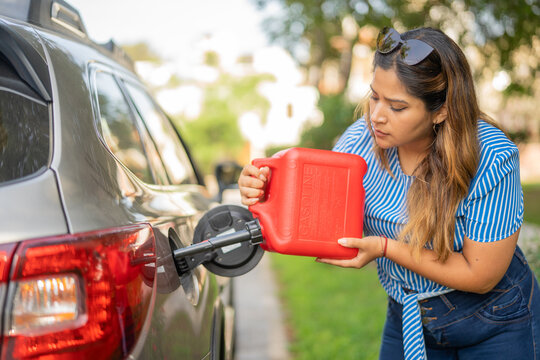 Woman putting gasoline in her car