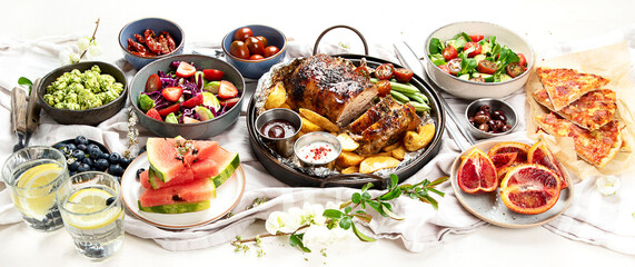 Family dinner or lunch. Many dishes on the table.