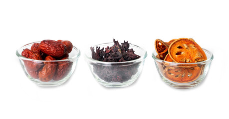 Three kinds of Asian dried fruits, bael, okra and jujube in glass bowls  are ingredients of healthy herbal tea.