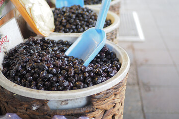 Buckets of olives for sale street food market