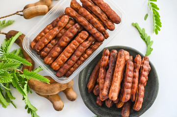 Tamarind sweet for food fruit ripe tamarinds on plate and white background, Tamarind peel in box package tropical fruits summer