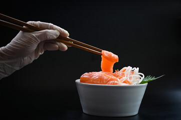 salmon sashimi food salmon fillet japanese menu with hands were holding the chopsticks to hold the salmon sashimi, fresh raw salmon fish for cooking food seafood fish