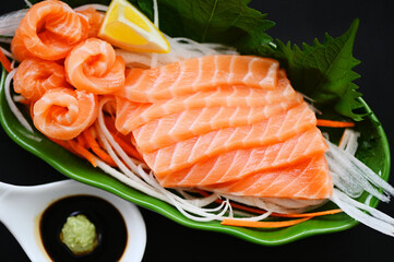 salmon sashimi food salmon fillet japanese menu with shiso perilla leaf lemon herb and spices, fresh raw salmon fish for cooking food seafood salmon fish with sauce and wasabi - top view