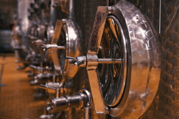 Closeup of steel barrels for fermentation in wine factory