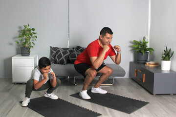 Boxing classes in the living room of his house between dad and son as a student teacher teaches techniques and practices of the sport